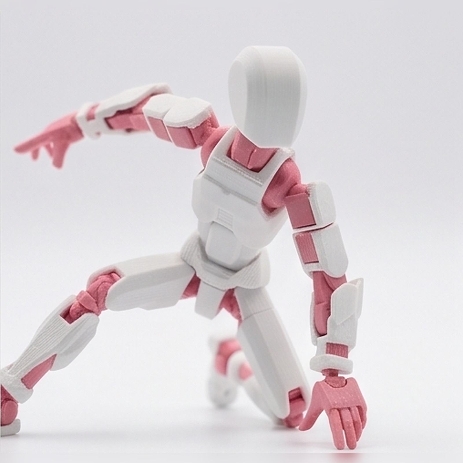 Flexible figurine posed in a crouch, white with pink joints